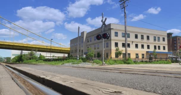 4K Man on Bike Crosses Railroad Tracks — Stock Video