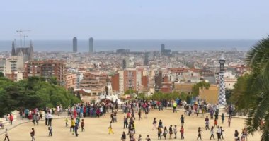tourists enjoy the panoramic views at  Park Güell