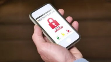 Bir adam onun ev güvenlik sistemi bir akıllı telefon ile uzaktan disarms. Genel cep telefonu ile bir kurgusal ekran arayüzü.