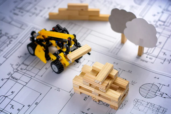 Bâtiments de machines de construction de jouets modèle de maison à partir de blocs de bois (barres) aux dessins . Images De Stock Libres De Droits