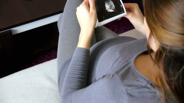 Gravid kvinna titta på ultraljud bild — Stockvideo