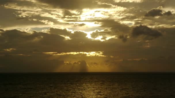 Light rays through clouds at sea — Stock Video