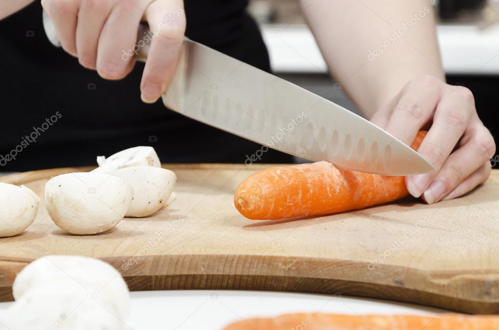Chopping carrots on a chopping board