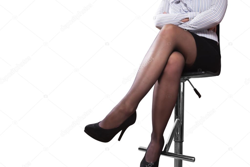 legs of a woman sitting on a bar stool