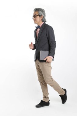 Beyaz arka planda duran kıdemli Asyalı öğretmen..