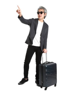 Beyaz arka planda bagajı olan kıdemli Asyalı işadamı..