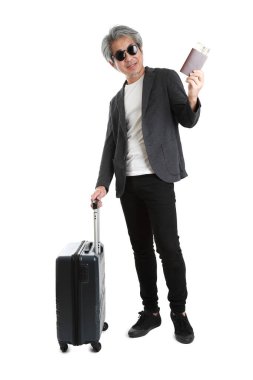 Beyaz arka planda bagajı olan kıdemli Asyalı işadamı..