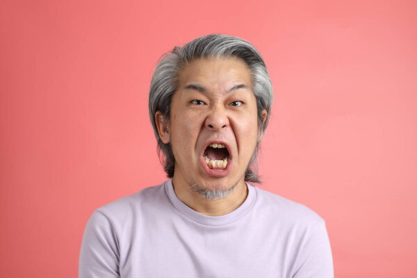 The senior Asian man portrait with no retouched skin in the pink background.