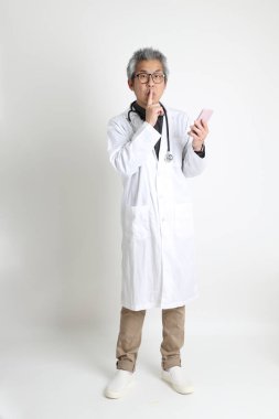 Beyaz arka plandaki kıdemli Asyalı doktor..