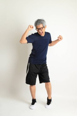 Beyaz arka planda spor giysileri olan Asyalı son sınıf öğrencisi..