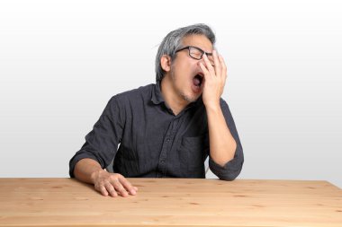 Masada oturan kıdemli Asyalı adam..