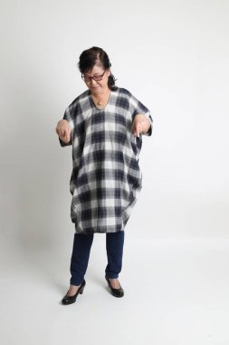 Beyaz arka planda duran yaşlı Asyalı kadın..