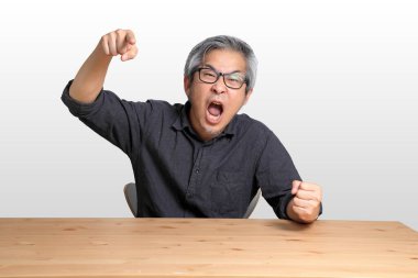 Masada oturan kıdemli Asyalı adam..