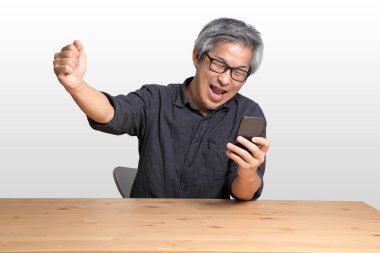 Masada oturan kıdemli Asyalı adam..