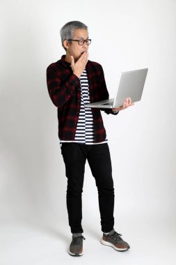 Beyaz arka planda duran Asyalı adam.