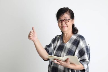 Beyaz arka planda duran yaşlı Asyalı kadın..