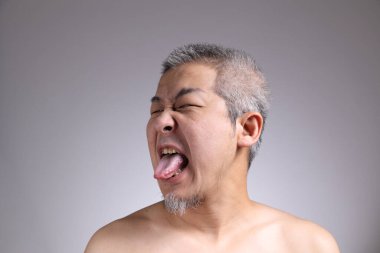 Gri arka planda Asyalı bir adamın portresi..