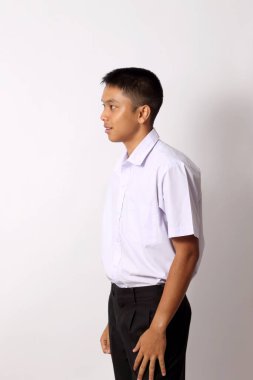 The young Thai student boy on the white background. clipart