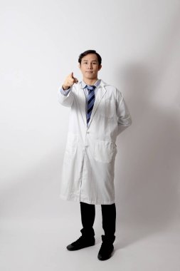 Beyaz arka planda duran Asyalı doktor..