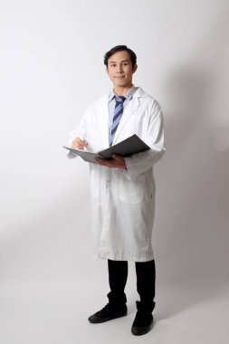 Beyaz arka planda duran Asyalı doktor..