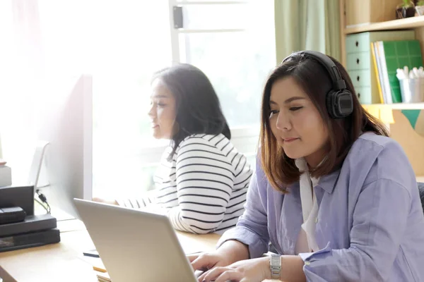 The Asian women working together in the house.