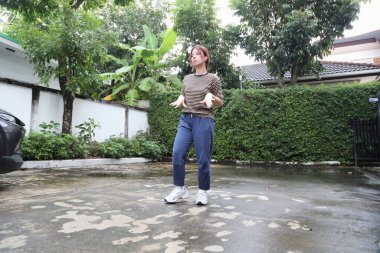 Güneydoğu Asyalı bir kadın egzersiz yapmadan önce ısınıyor.