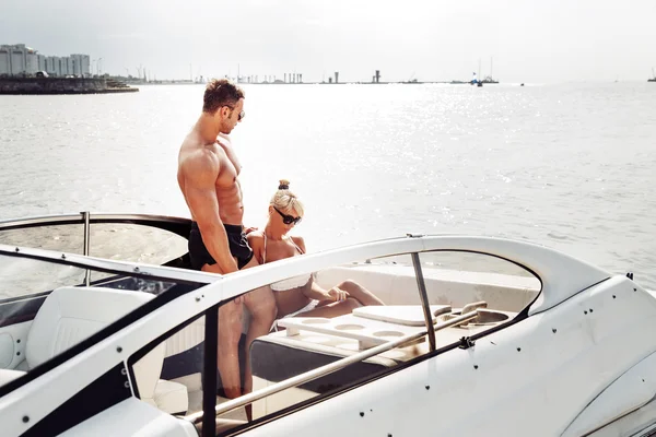 Elegant beautiful couple on boat in a swim wear — Stock Photo, Image