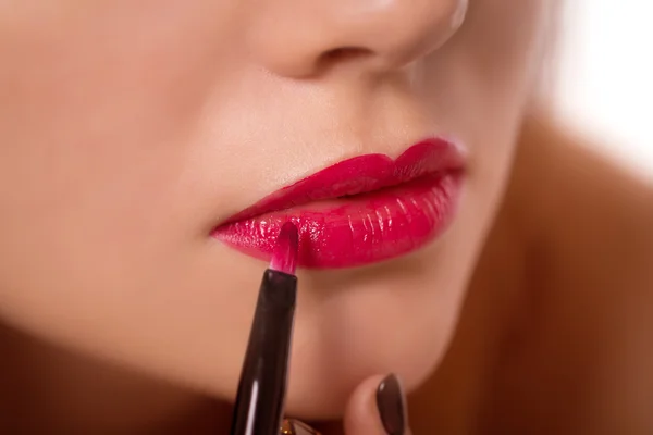 Part attractive woman face apply fashion red lipstick makeup Stock Picture