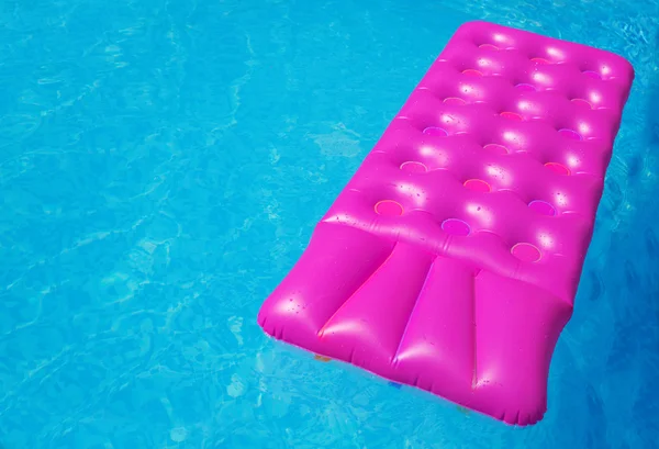 Pembe şişme yüzme havuzunda. Tatil arka plan.