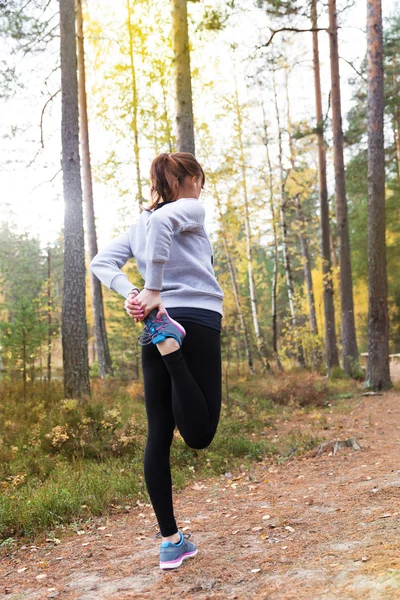 Jovem mulher correr no outono as luzes do pôr do sol da floresta — Fotografia de Stock