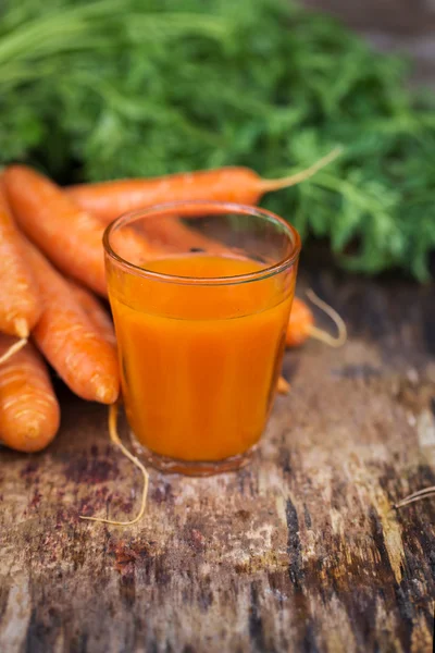 Carrot juice on wooden background — Stock Photo, Image