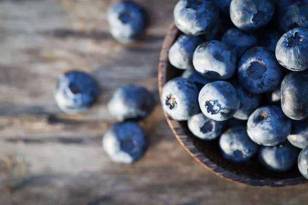 Fresh sweet tasty blueberries on wooden background