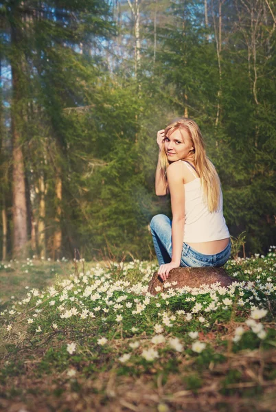 Young pretty blond woman on a meadow flowers — Stock Photo, Image