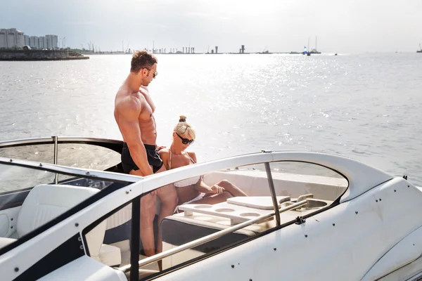 Elegant beautiful couple on a boat in a swim wear — Stock Photo, Image