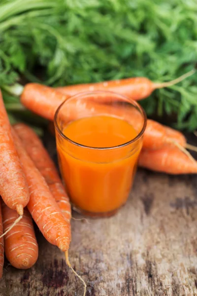 Carrot juice on wooden background — Stock Photo, Image