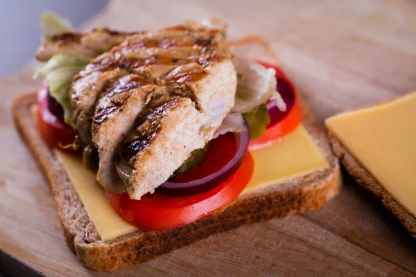 Fresh homemade grilled chicken sandwich on wood — Stock Photo, Image