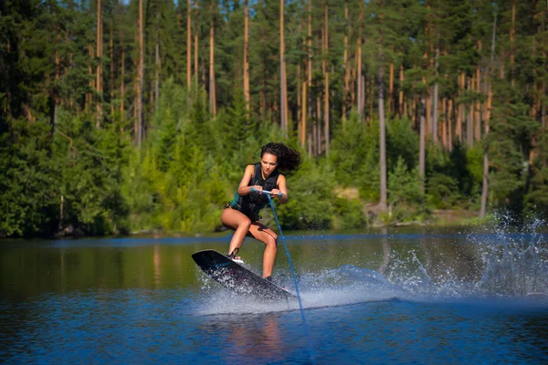 Young woman study riding wakeboarding on a lake — Stock Photo, Image