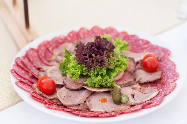 Served table layout with meat snack plate — Stock Photo, Image