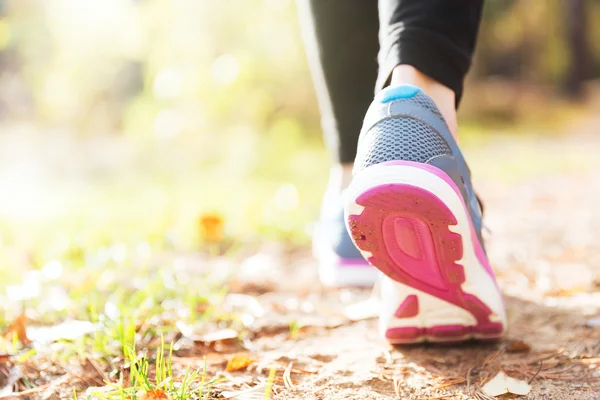 Woman running legs in sunset forest — Stock Photo, Image