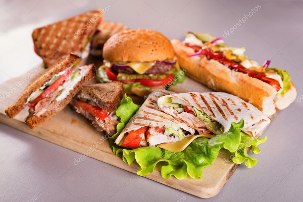 Fast food plate with burger hot dog sandwiches and chicken wrap — Stock