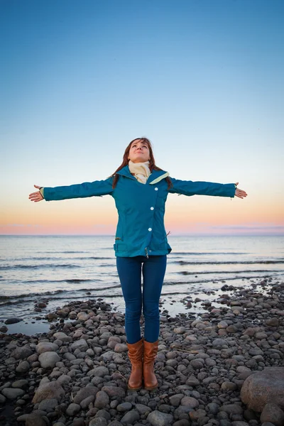 Woman on the cost of the lake in sunset lights — Stock Photo, Image