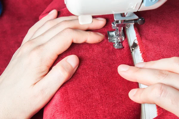 Sewing machine, red fabric and women's hands — Stock Photo, Image