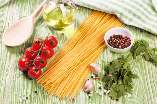 Pasta ingredients on green background. — Stock Photo, Image