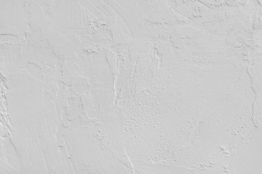 Close up, macro of white painted textured stucco wall with rough plaster, concrete surface texture. Abstract background, backdrop for design, wallpaper art or decoration projects.
