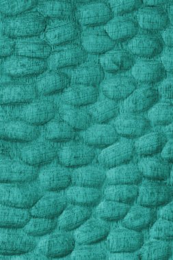 Oyulmuş oval desenleri ve ahşap tahılları olan desenli turkuaz renkli ahşap yüzey. Tasarım, zanaat veya doğal doku ve materyal temaları için soyut doku arka planı ideali.