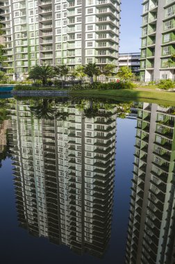 Bina ve gökyüzünün yansıması ile sakin göl