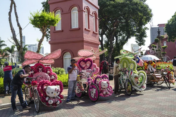 Melaka, Malaysia - August 2,2015: Decorated trishaw with colorful flowers and doll for hire at Malacca city, Malaysia. — Stock Photo, Image