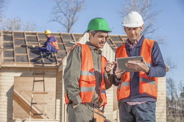 Foreman och lekman på byggarbetsplats — Stockfoto