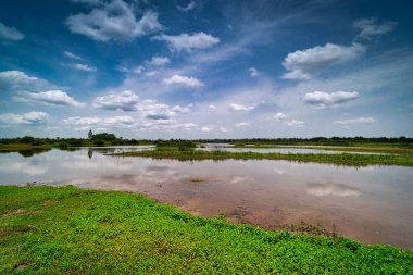 Yansıma gölü olan manzara, gökyüzü ve bulutlu su.