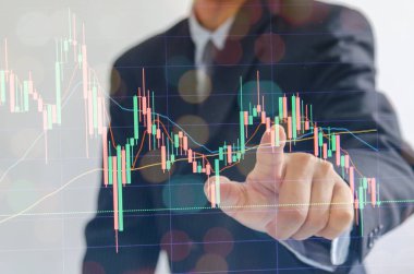 business man wearing a suit pointing fingers stock marketing finance on modern virtual interface.